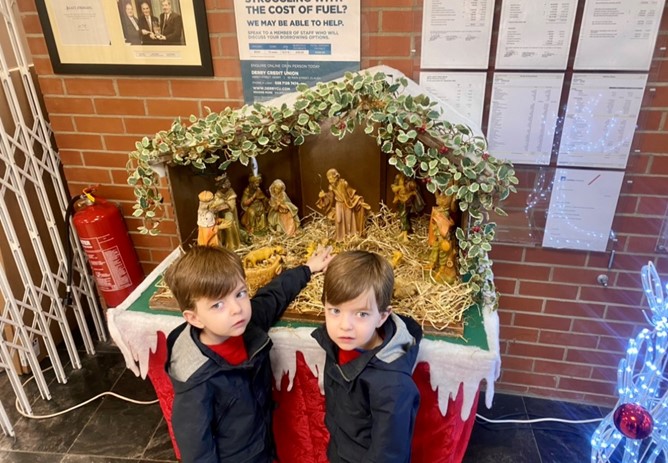 Aodhan and Caomhan Place the baby Jesus in the Crib
